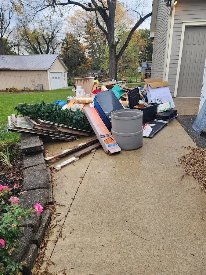 Dumpster being loaded with debris for 12 Yard Dumpster Rental in Lathrop
